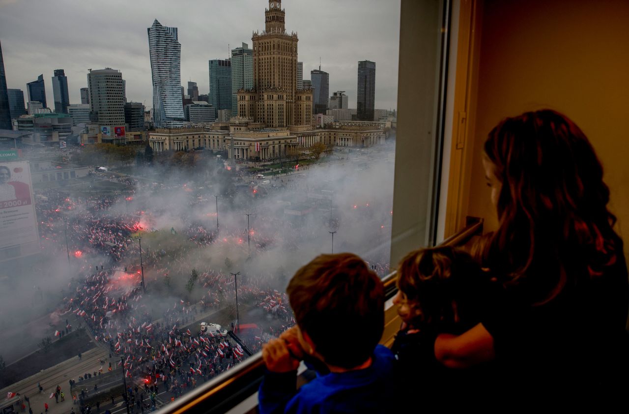 Children watch from a window in Warsaw, Poland, as thousands of people gather for an Independence Day march on Friday, November 11.