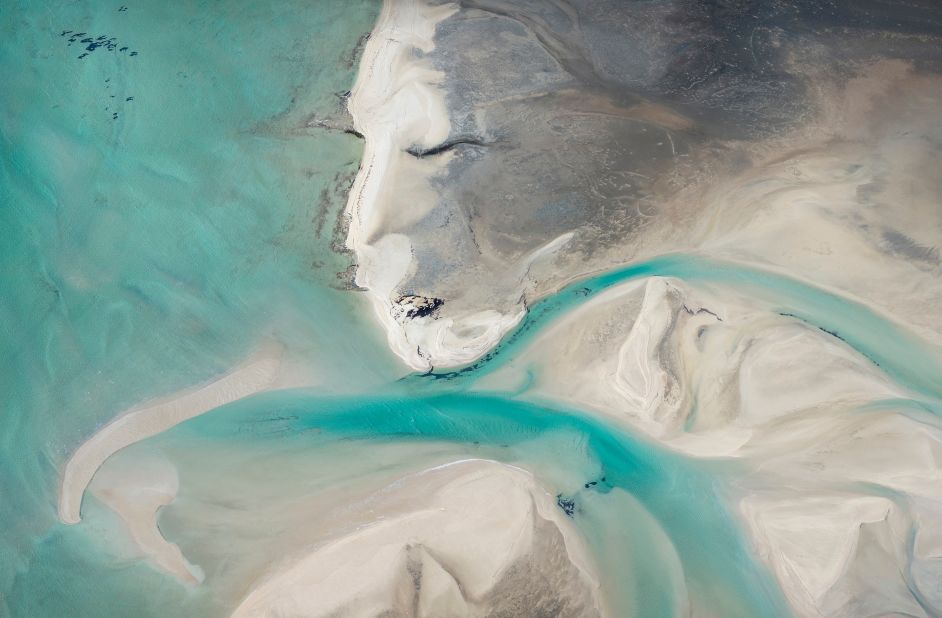 Winning in the "Abstract & Details" category, this photo was taken at Gutharraguda/Shark Bay in Western Australia. Photographer Mieke Boynton titled it "Ocean Deity," as the sand seems to draw a face: "If you look closely, her eyes have been sewn shut by tire tracks," she says. "More than 6,000 marine turtles live in Gutharraguda/Shark Bay, including the globally endangered green turtle (Chelonia mydas) and loggerhead turtle (Caretta caretta). When people drive along the beach in 4WDs four-wheel drives, they put the lives of turtles at risk, as this is where they nest."