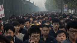 FILE-- Workers heading to a Foxconn factory dedicated to iPhones in Zhengzhou, China, Oct. 20, 2015.  Such factories can employ hundreds of thousands of people who assemble, test and package Apple products. Apple decided in 2012 to produce a high-end Mac in Texas. The problems that surfaced illustrate the challenges of domestic manufacturing. (Gilles Sabrie/The New York Times)