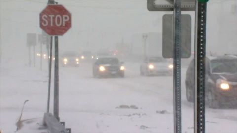 Vehicles move through the snow in Buffalo, New York.