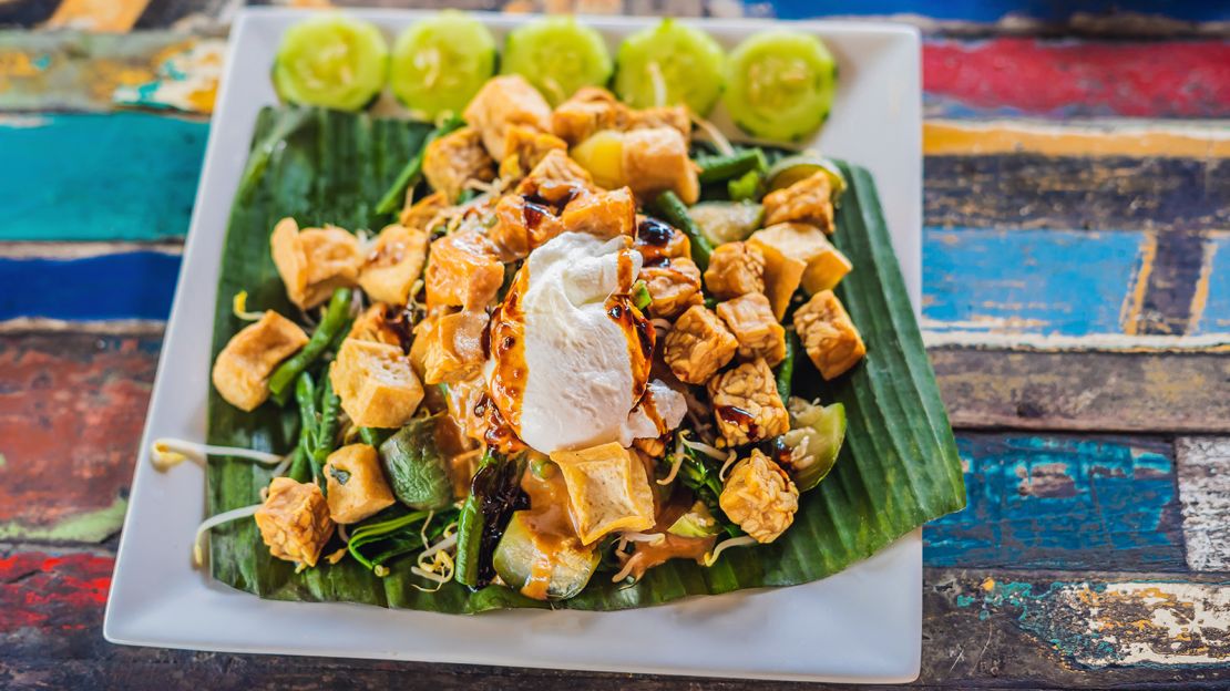 A classic gado gado is served with chopped vegetables, an egg and sometimes, slices of tofu or tempeh. It is often dressed with roasted peanut sauce.