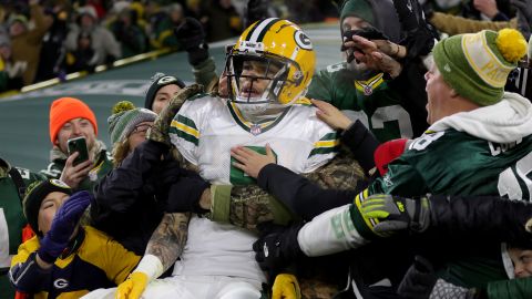 Christian Watson celebrates scoring a touchdown against the Titans at Lambeau Field.