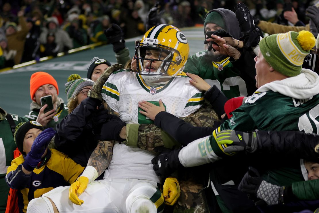 Christian Watson celebrates scoring a touchdown against the Titans at Lambeau Field.