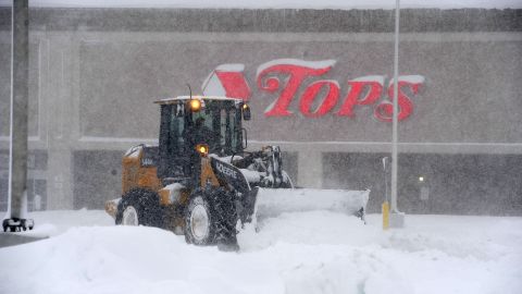 A front end loader digs up a supermarket parking lot in Hamburg, New York on Friday after the storm.