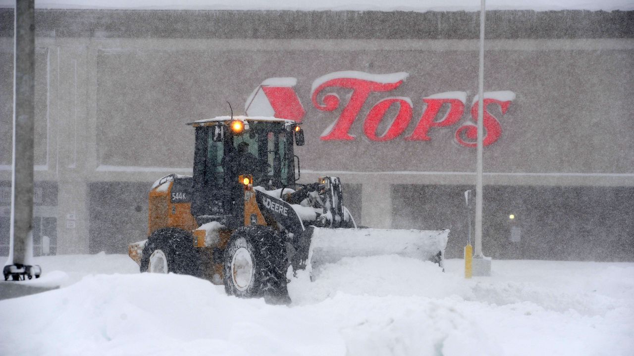 A front loader digs out a supermarket parking lot Friday after the storm hit Hamburg, New York.