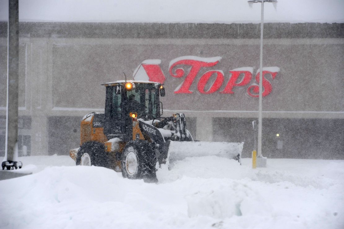 A front loader digs out a supermarket parking lot Friday after the storm hit Hamburg, New York.