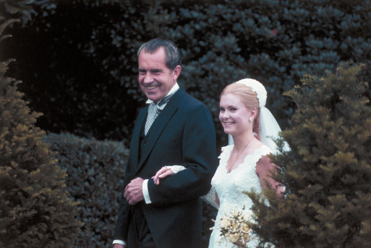 President Richard Nixon escorts his daughter Tricia to the White House Rose Garden for her marriage to Edward Finch Cox in 1971.