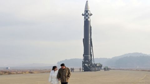 North Korean leader Kim Jong Un and his daughter walk away from an ICBM in this undated photo released by North Korea's Korean Central News Agency on November 19, 2022. 