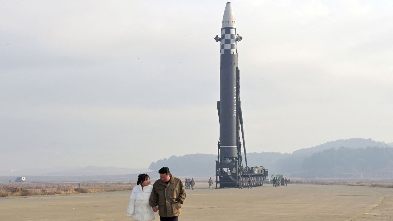 North Korean leader Kim Jong Un and his daughter walk away from an intercontinental ballistic missile (ICBM) in this undated photo released on November 19, 2022, by North Korea's Korean Central News Agency. 