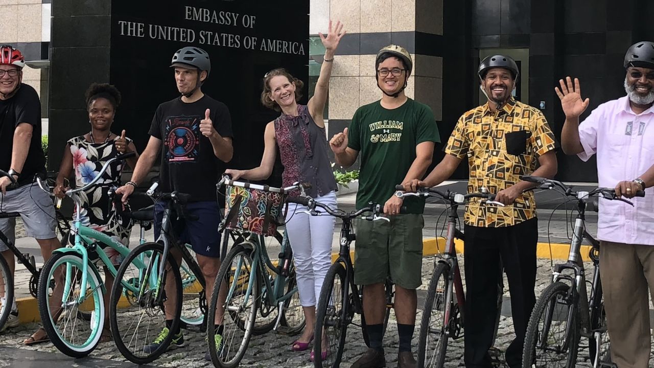 Sarah Langenkamp seen here with her arm raised, during "Bike to Work Day" in 2018, during the family's time in the Ivory Coast. 