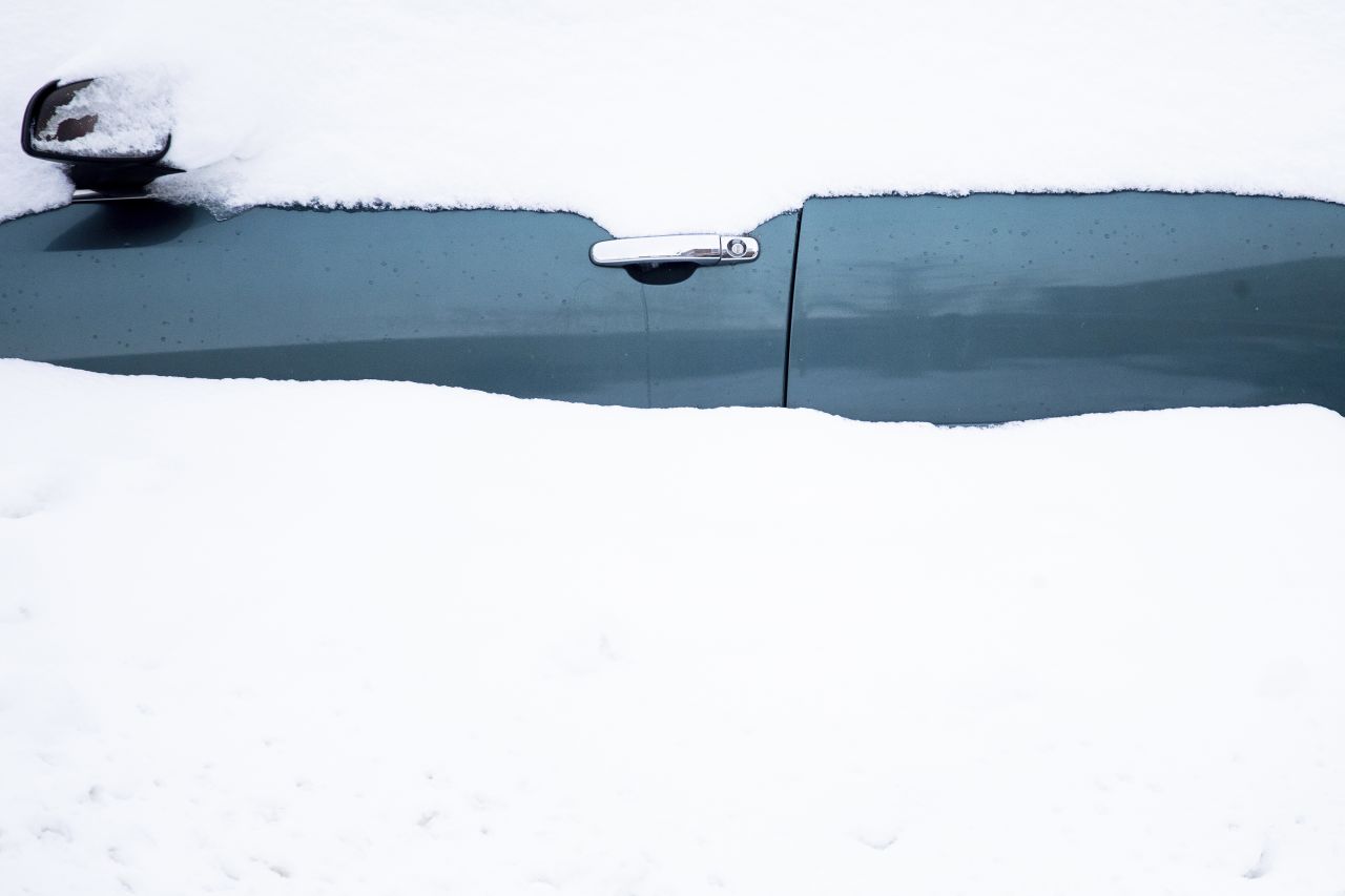 A car sits in a snowdrift on Friday.