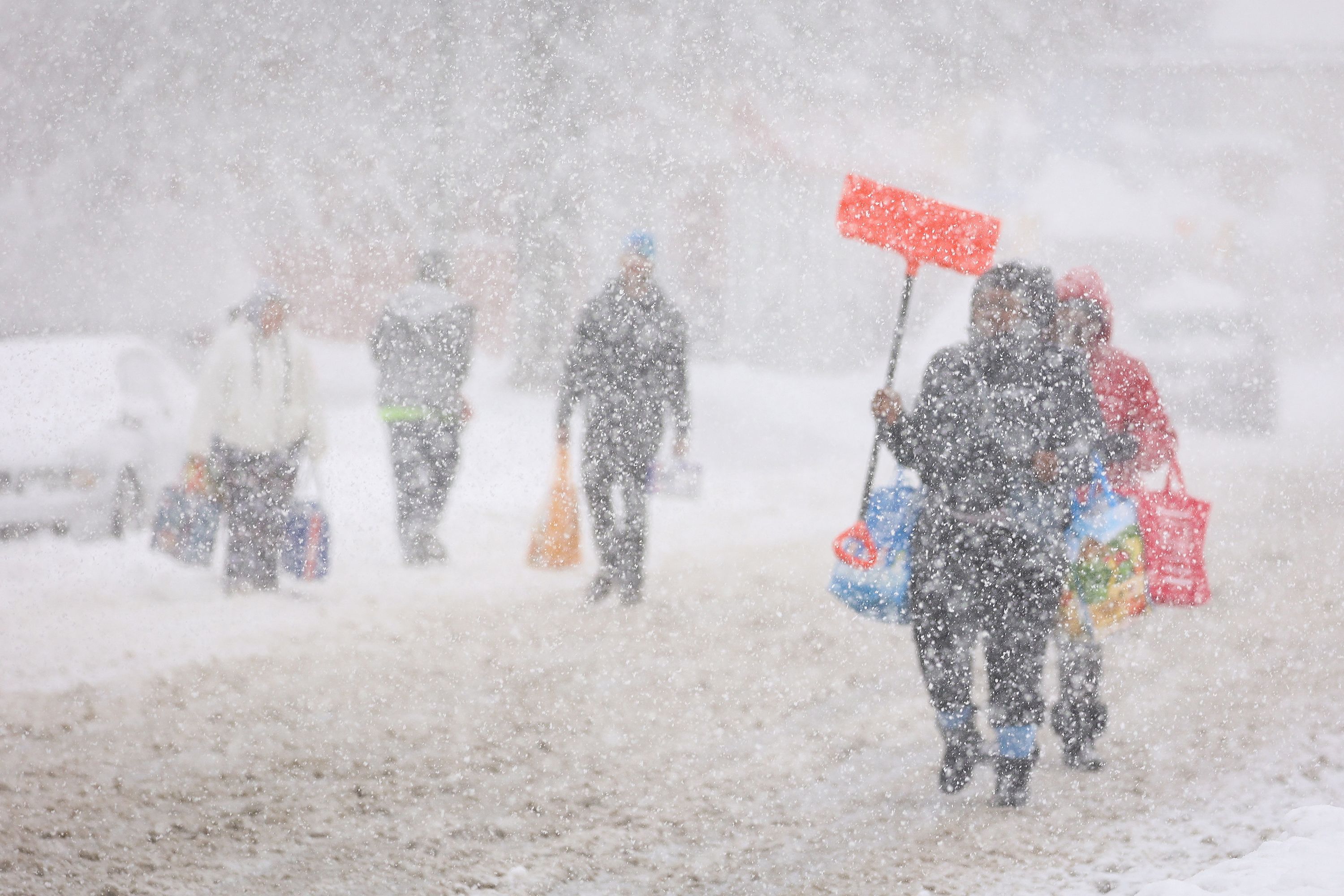 Residents walk in the snow on Friday.