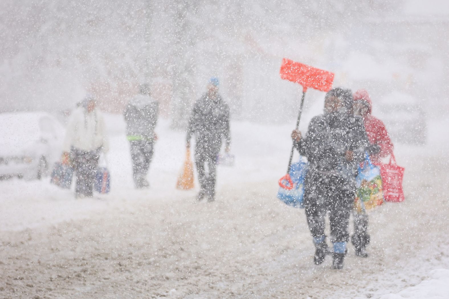 Residents walk in the snow on Friday. 