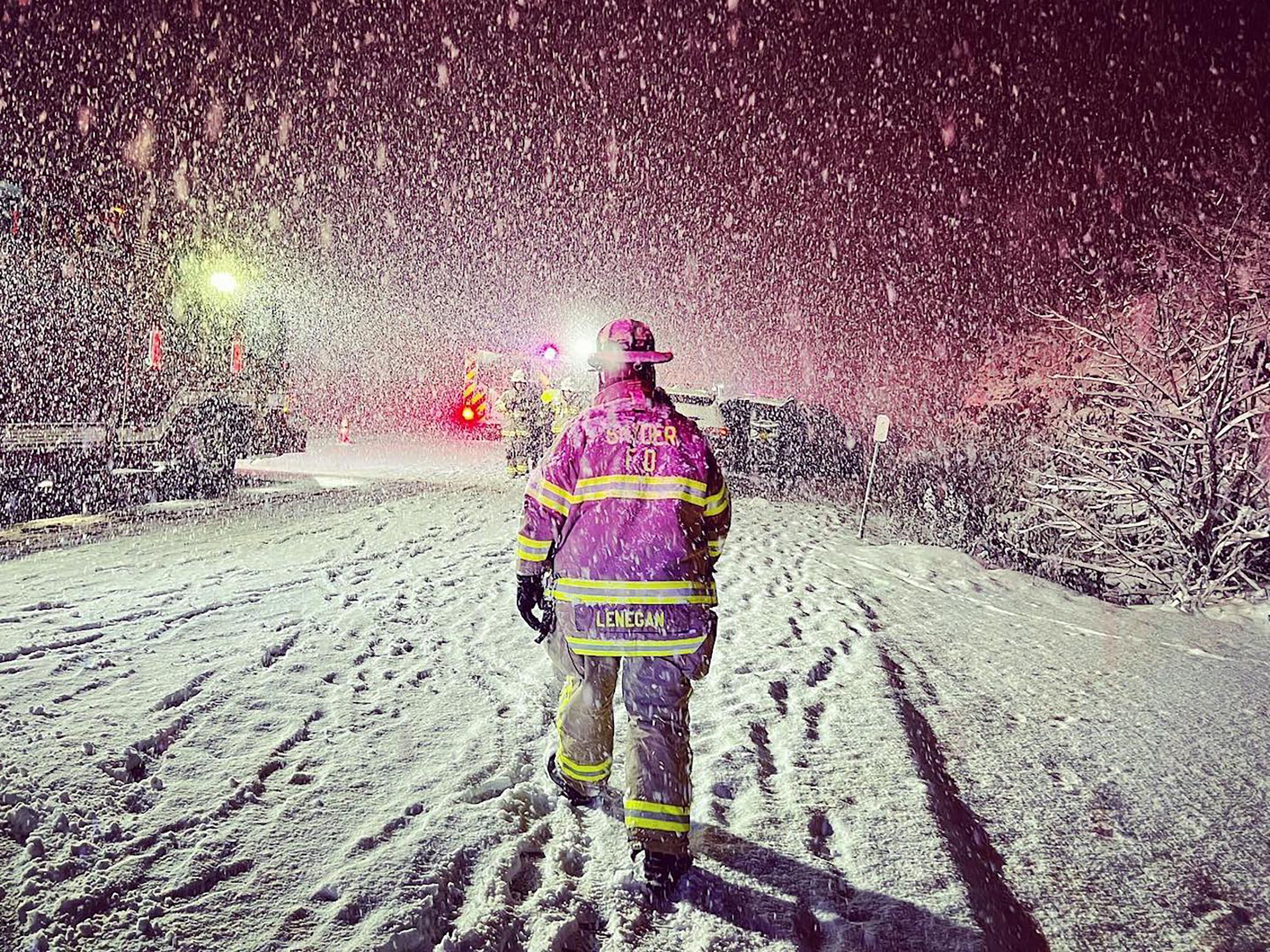 Firefighters work the scene of a car accident on Thursday.