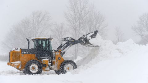 A loader on Friday digs out a parking lot in Hamburg, New York, after an intense lake effect snow storm dumped several feet of snow around Buffalo and surrounding suburbs.
