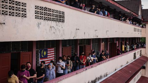Voters wait in line at a polling station during the 15th general election in Kuala Lumpur, Malaysia, on November 19, 2022. 