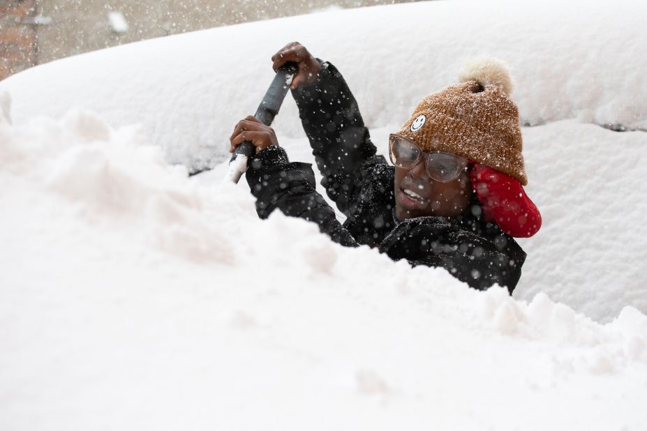 Zaria Black clears snow from her car on Friday. 