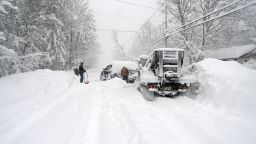Good Samaritans help dig out a plow after an intense lake-effect snowstorm impacted the area on November 18, 2022 in Hamburg, New York.