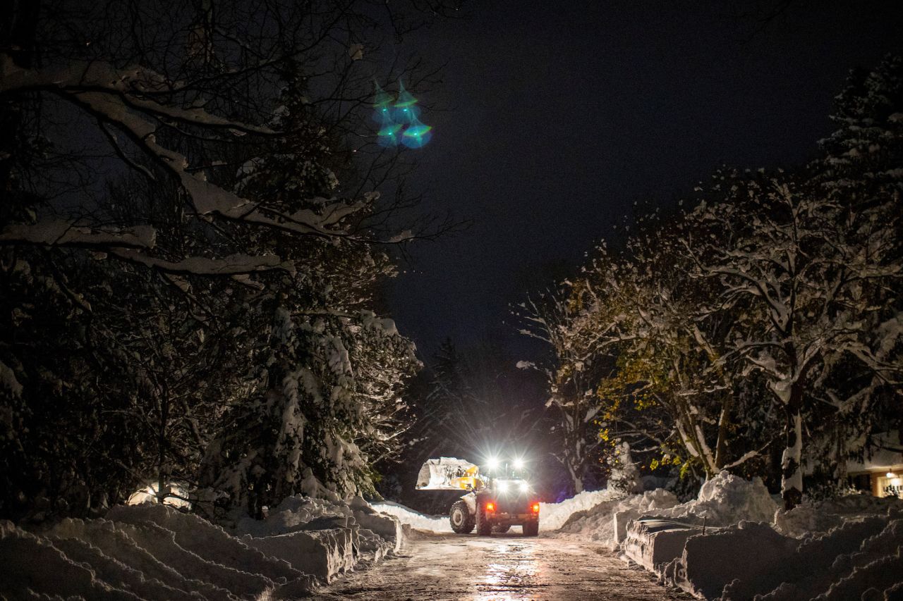 A snow plow works along a street during a break in the snowstorm hitting the Buffalo area in Orchard Park, New York, on Saturday, November 19. 