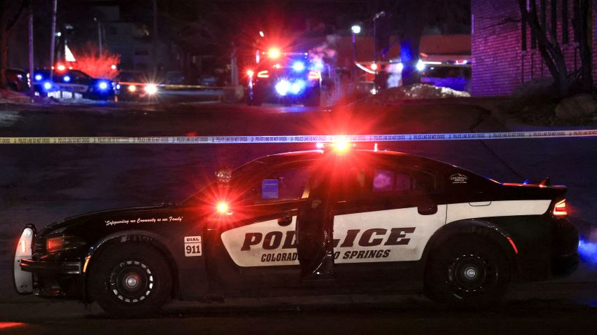 A police officer sits in their vehicle while responding to a mass shooting at the Club Q gay nightclub in Colorado Springs, Colorado, U.S., November 20, 2022.