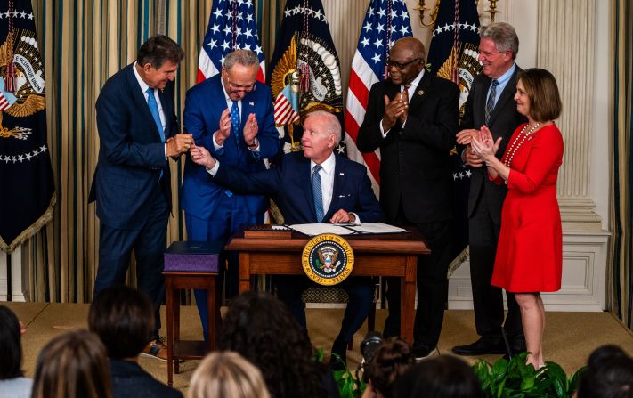 Biden hands West Virginia Sen. Joe Manchin the pen used to sign the <a href="index.php?page=&url=https%3A%2F%2Fwww.cnn.com%2F2022%2F08%2F16%2Fpolitics%2Fbiden-inflation-reduction-act-signing%2Findex.html" target="_blank">Inflation Reduction Act</a> at the White House in August 2022. Also pictured from left are Senate Majority Leader Chuck Schumer, House Majority Whip Rep. Jim Clyburn, New Jersey Rep. Frank Pallone and Florida Rep. Kathy Castor. 