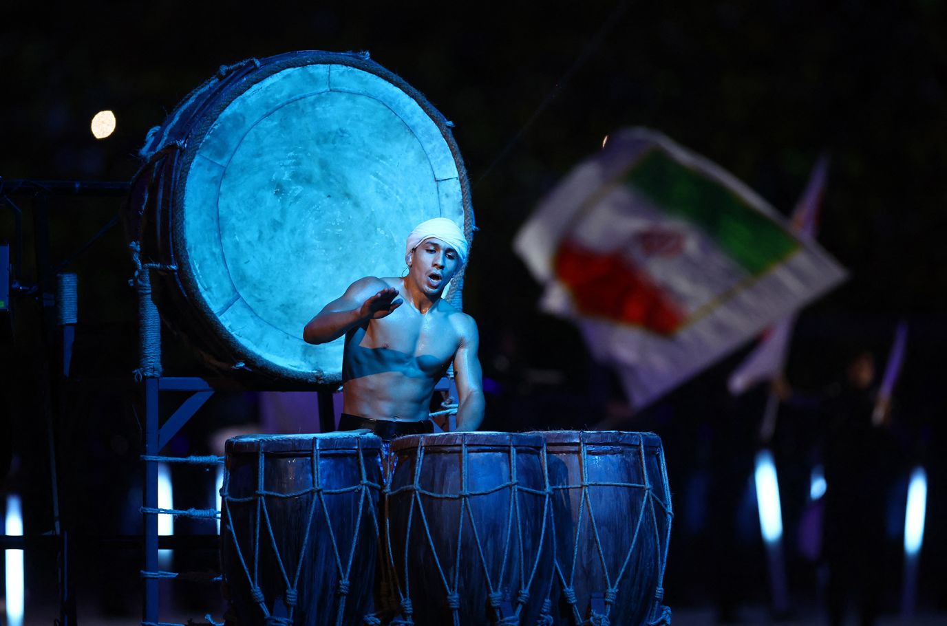 A performer plays drums during the opening ceremony.