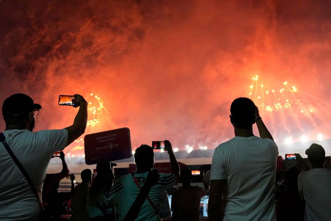 People watch as fireworks go off before the start of the World Cup at the Al Bayt Stadium. 