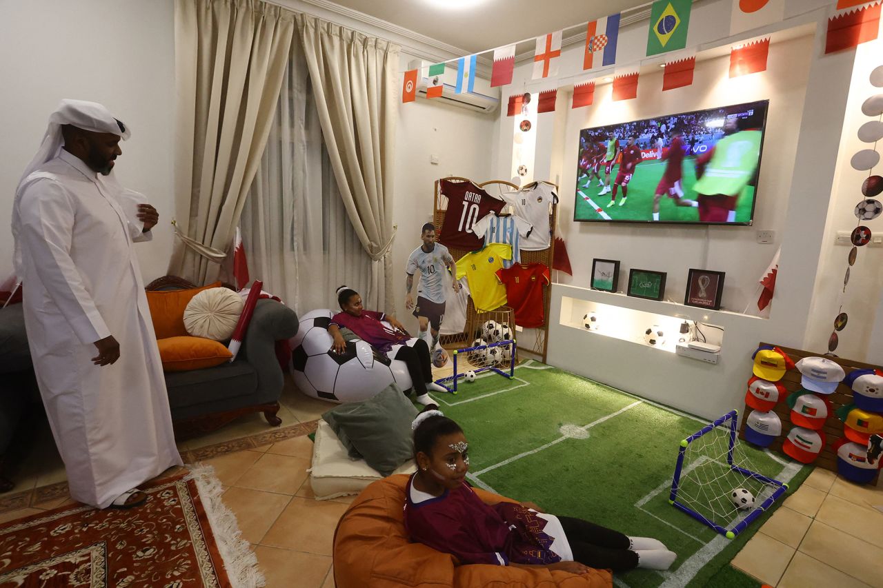 A family watches the opening match from their home in Doha.