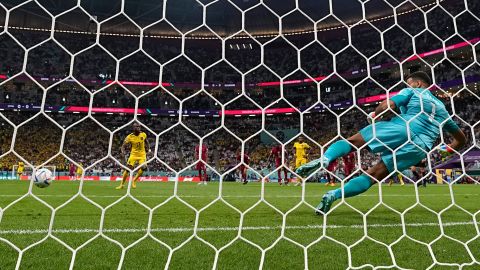 Valencia scores past Qatar goalkeeper Saad Al-Sheeb to score Ecuador's opening goal. 