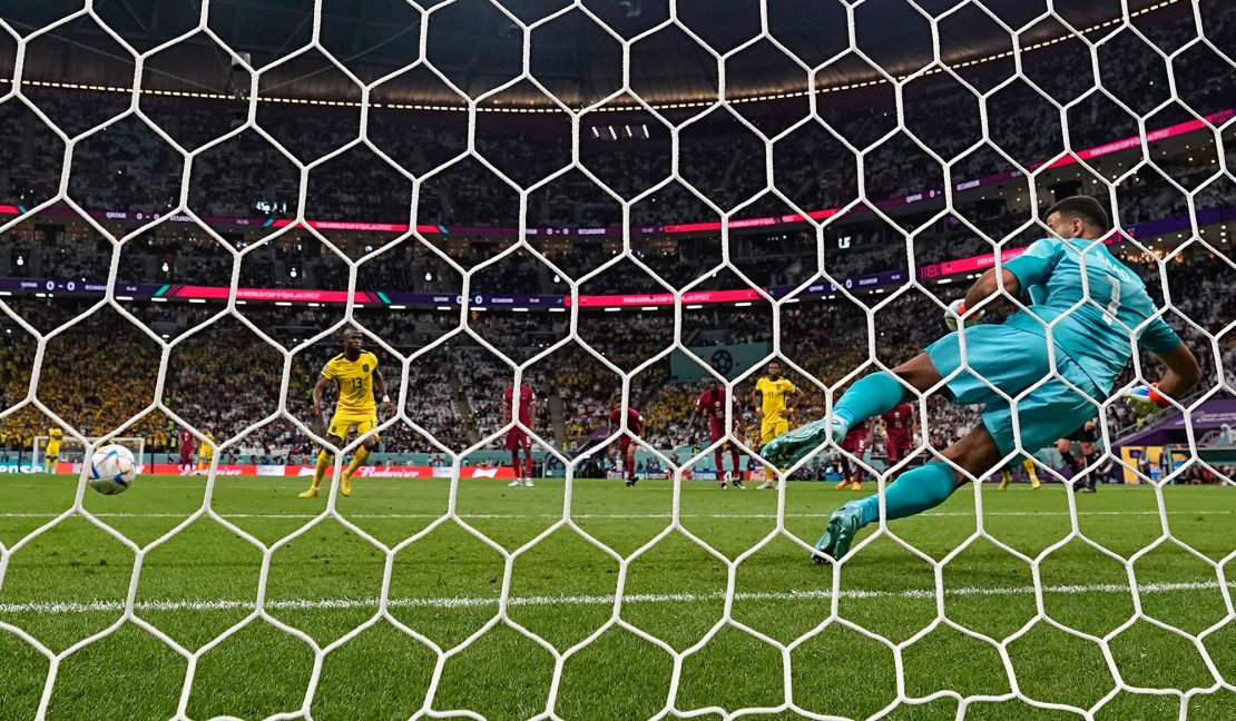 Valencia scores past Qatar's goalkeeper Saad Al Sheeb for Ecuador's opening goal. 