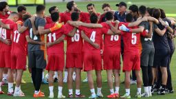 Iran's coach Carlos Queiroz (R, with cap) gathers with the players during a training session at the Al Rayyan SC in the Al Rayyan district in Doha on November 19, 2022, ahead of the Qatar 2022 World Cup football tournament. 