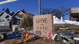 Bouquets of flowers and a sign reading "Love Over Hate" are left near Club Q, an LGBTQ nightclub in Colorado Springs, Colorado, on November 20, 2022. - At least five people were killed and 18 wounded in a mass shooting at an LGBTQ nightclub in the US city of Colorado Springs, police said on November 20, 2022. (Photo by Jason Connolly / AFP) (Photo by JASON CONNOLLY/AFP via Getty Images)