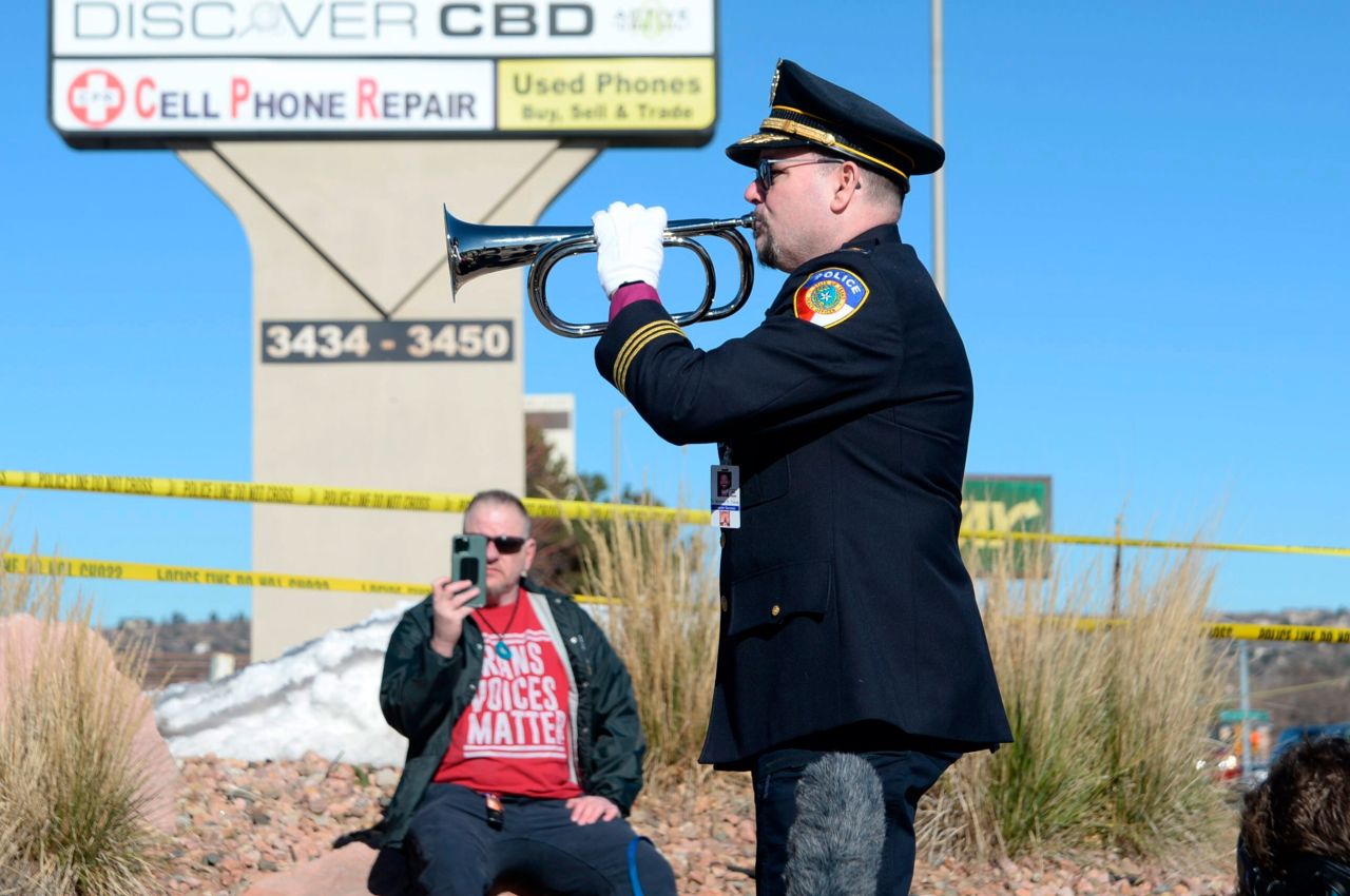 Michael Robert Travis performs taps while his husband, Michael Travis, films on his phone near the LGBTQ nightclub in Colorado Springs on Sunday.