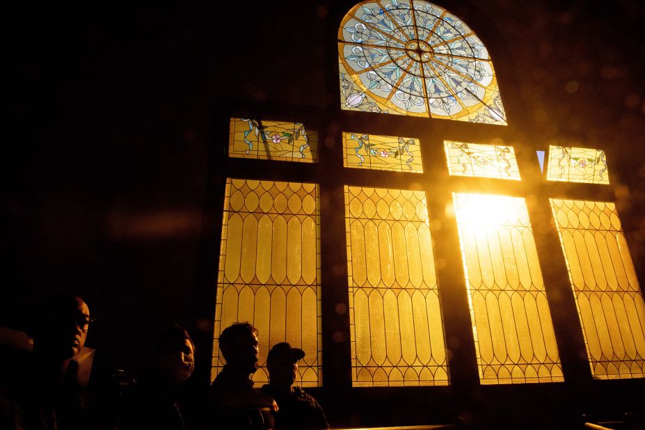 Community members gather for a vigil Sunday at the All Souls Unitarian Church in Colorado Springs.