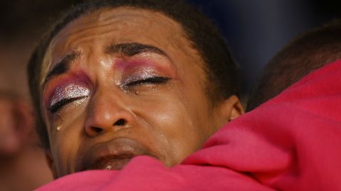 Lia-Jane Seals hugs RJ Lewis at a vigil for the victims of the Club Q shooting.