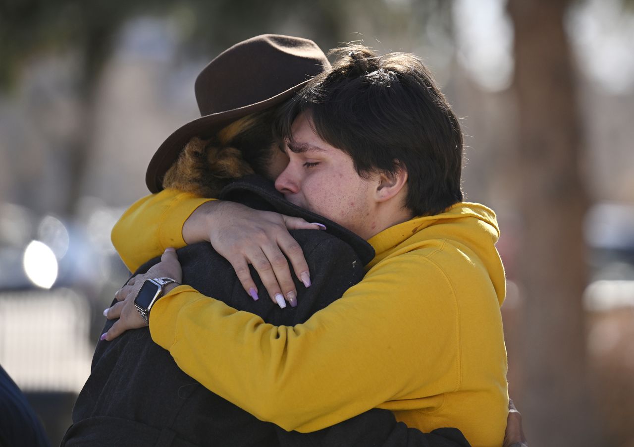 Leia-jhene Seals, left, hugs Carter Rodriguez outside All Souls Unitarian Church before a Sunday vigil for the victims of the Club Q attack.