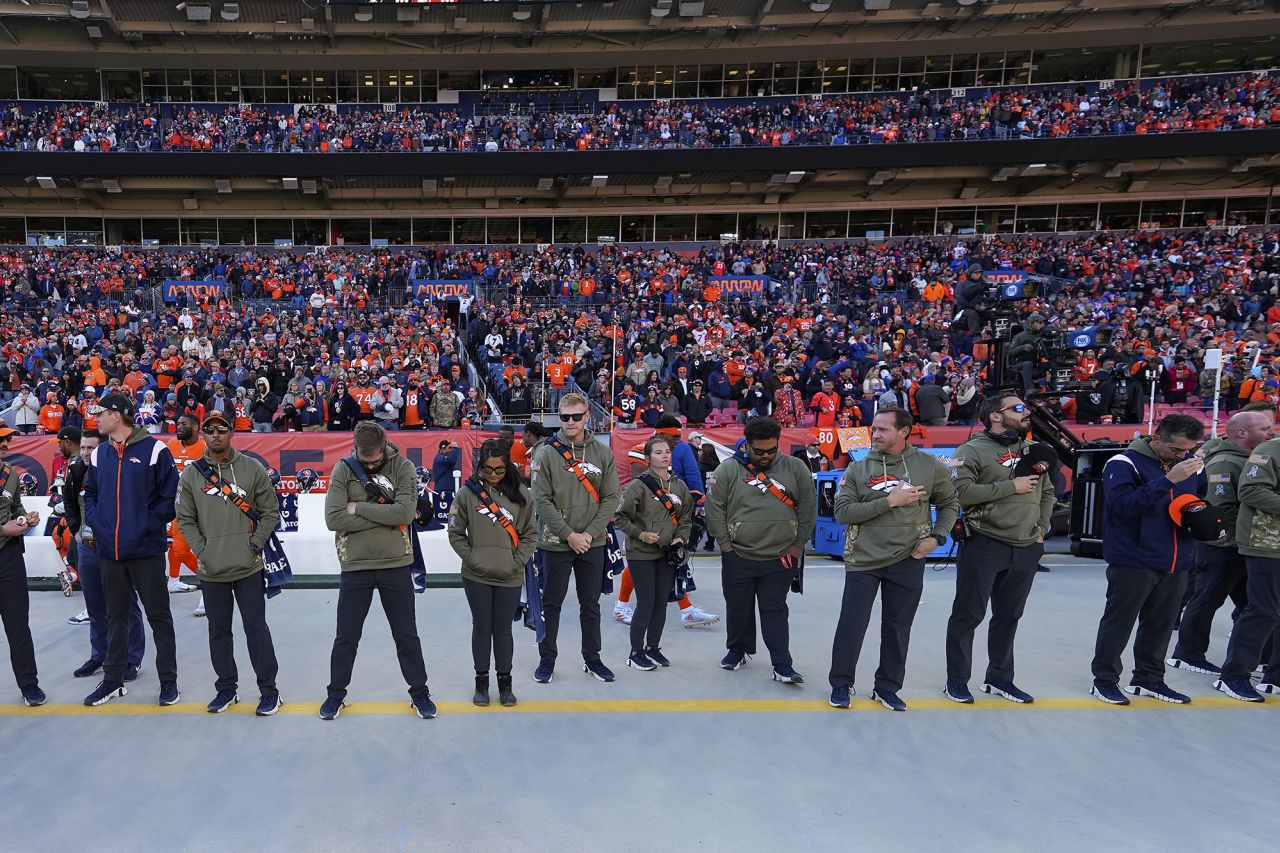 Denver Broncos staff members and fans observe a moment of silence for the victims of the nightclub shooting in Colorado Springs.