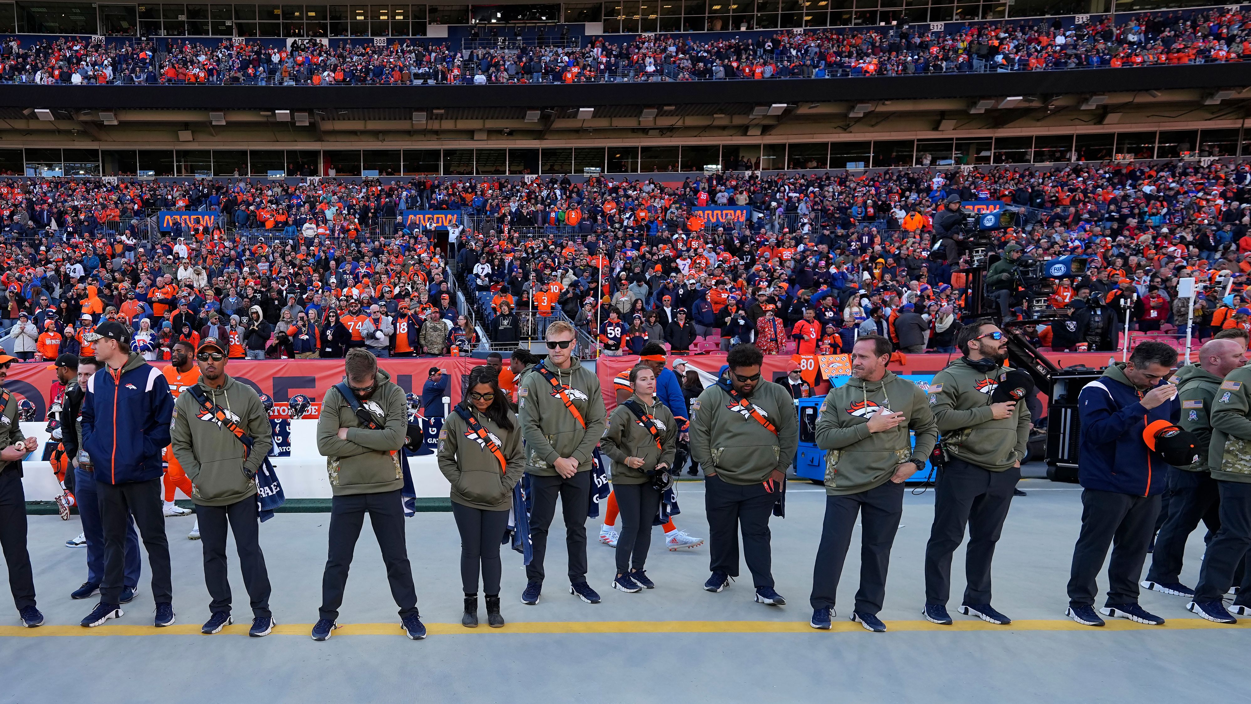 Ahead of their game against the Las Vegas Raiders on November 20, Denver Broncos staff members and fans observe a moment of silence for victims of <a href="index.php?page=&url=https%3A%2F%2Fwww.cnn.com%2F2022%2F11%2F20%2Fus%2Fgallery%2Fcolorado-lgbtq-club-shooting%2Findex.html" target="_blank">an attack at a Colorado Springs LGBTQ nightclub</a> late Saturday. A gunman entered the Club Q nightclub and opened fire, killing at least 5 people and injuring 19 others, police said.