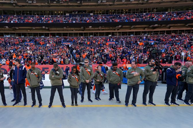 Ahead of their game against the Las Vegas Raiders on November 20, Denver Broncos staff members and fans observe a moment of silence for victims of <a href="index.php?page=&url=https%3A%2F%2Fwww.cnn.com%2F2022%2F11%2F20%2Fus%2Fgallery%2Fcolorado-lgbtq-club-shooting%2Findex.html" target="_blank">an attack at a Colorado Springs LGBTQ nightclub</a> late Saturday. A gunman entered the Club Q nightclub and opened fire, killing at least 5 people and injuring 19 others, police said.