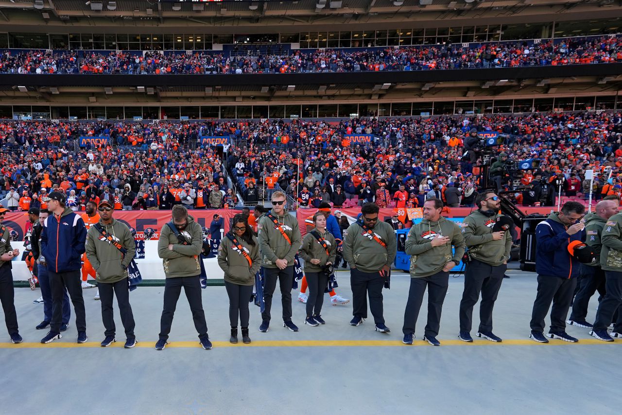 Ahead of their game against the Las Vegas Raiders on November 20, Denver Broncos staff members and fans observe a moment of silence for victims of an attack in a Colorado Springs gay nightclub late Saturday. A gunman entered the Club Q nightclub and opened fire, killing at least 5 people and injuring 25 others, police said.