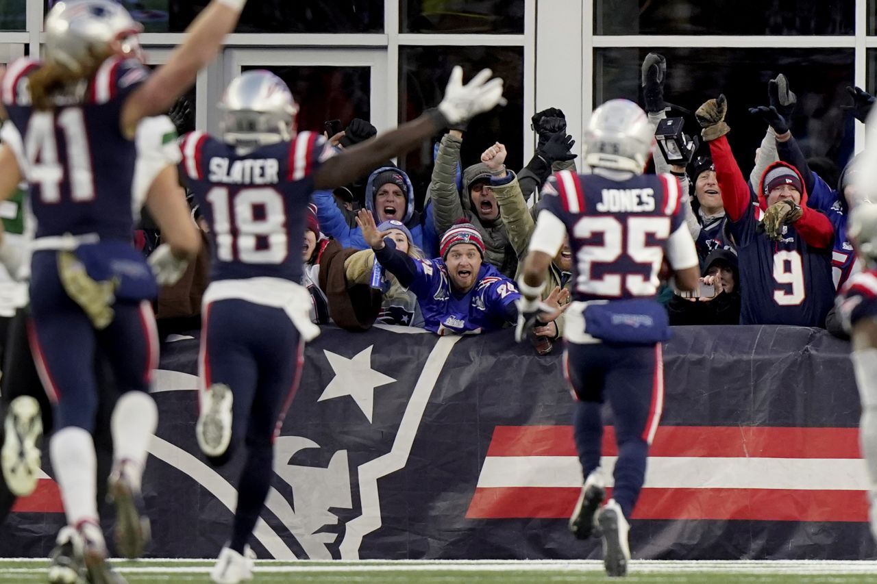 New England Patriots fans celebrate as cornerback Marcus Jones scores an 84-yard punt return in the final 30 seconds of the game to give the Pats a 10-3 win over division rivals, the New York Jets.