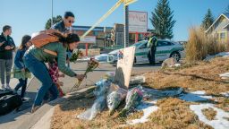COLORADO SPRINGS, CO - NOVEMBER 20:

Kara and CF Too (last name is Too) and her children (she didnt want to give their names) place flowers at the police tape for a growing memorial related to the shooting inside Club O last night on, Sunday November 20, 2022 in Colorado Springs, Colorado. 
(Photo by Matthew Staver/For the Washington Post)
