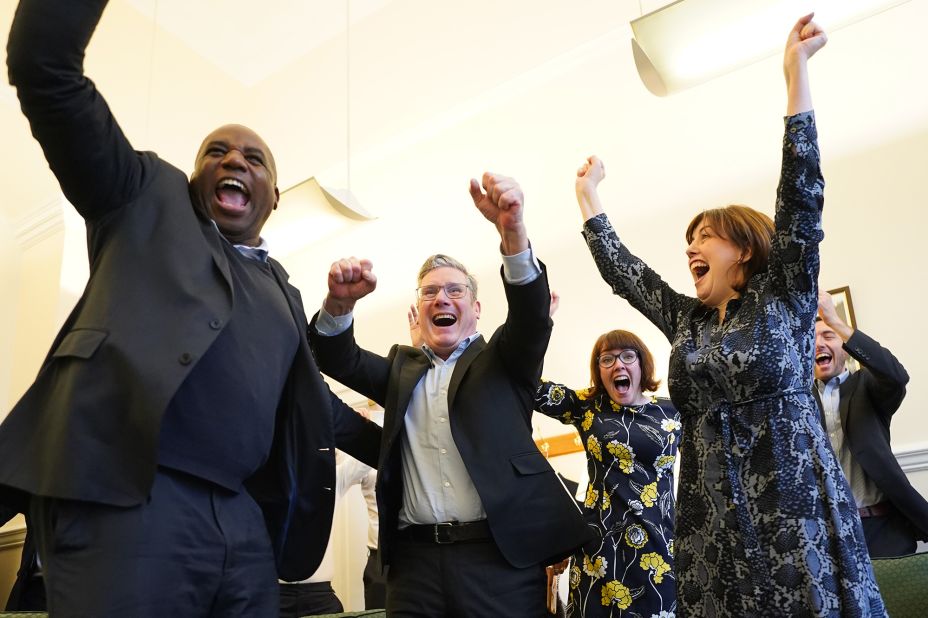 Labour Party leader Keir Starmer, center, celebrates England's second goal with colleagues David Lammy, left, and Lucy Powell, right, in his parliamentary office at the Palace of Westminster in London.