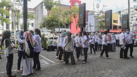 People gather outside buildings in the business district of Jakarta, Indonesia's capital, amid fears of aftershocks. 
