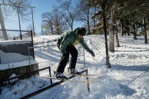 A resident hits a rail off of a home-made snow kicker after a snowstorm near Hoyt Lake in Buffalo on Sunday.