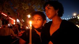 LOS ANGELES, CA - NOVEMBER 20: Jacky Santiago, 24, left, and Khayra (cq), Mentado, 22, both of Los Angeles, attend a candlelight vigil along Santa Monica Blvd. in front of Roccos on Sunday, Nov. 20, 2022 in Los Angeles, CA. City leaders and community organizations hold a candlelight vigil in solidarity with the LGBTQ community of Colorado Springs, Colorado, where at least five people were shot to death at a nightclub late Saturday. (Gary Coronado / Los Angeles Times via Getty Images)