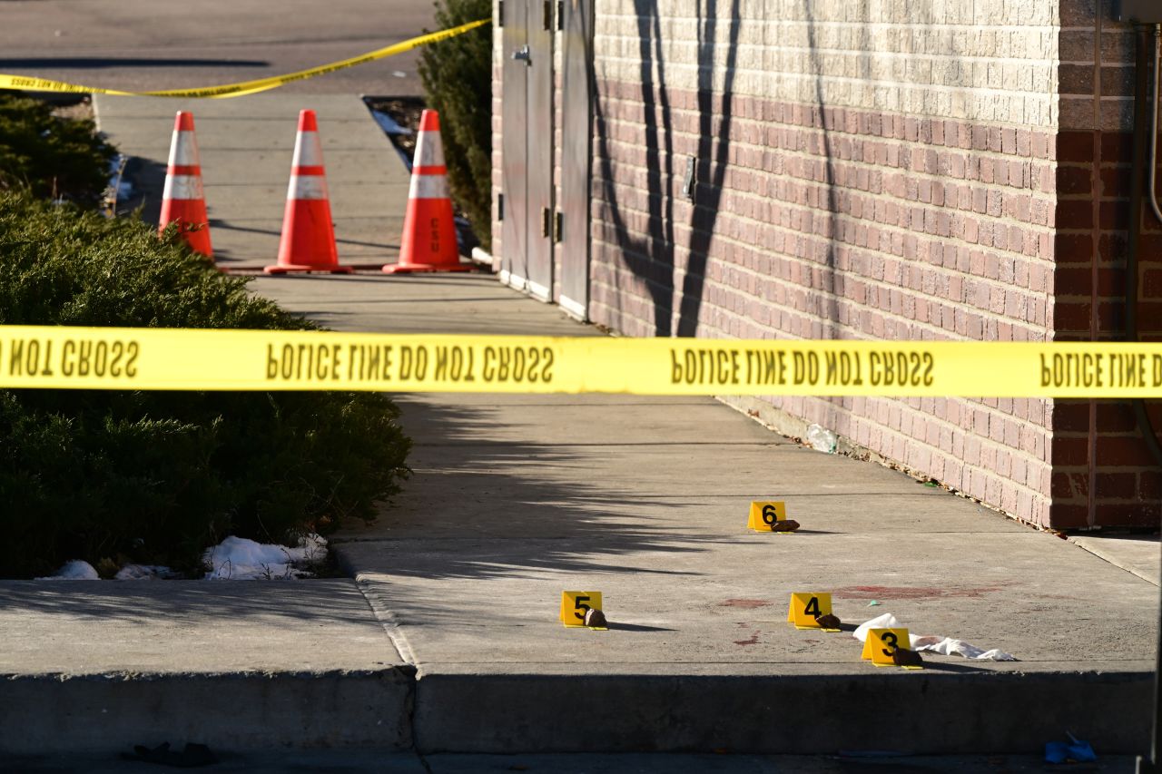 Evidence markers are placed where a victim was found near Club Q.