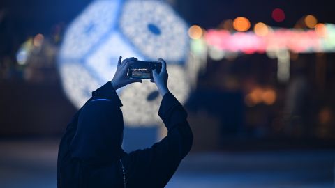 A football fan takes a picture at the Corniche ahead of the FIFA World Cup Qatar 2022 on November 19, 2022 in Doha..