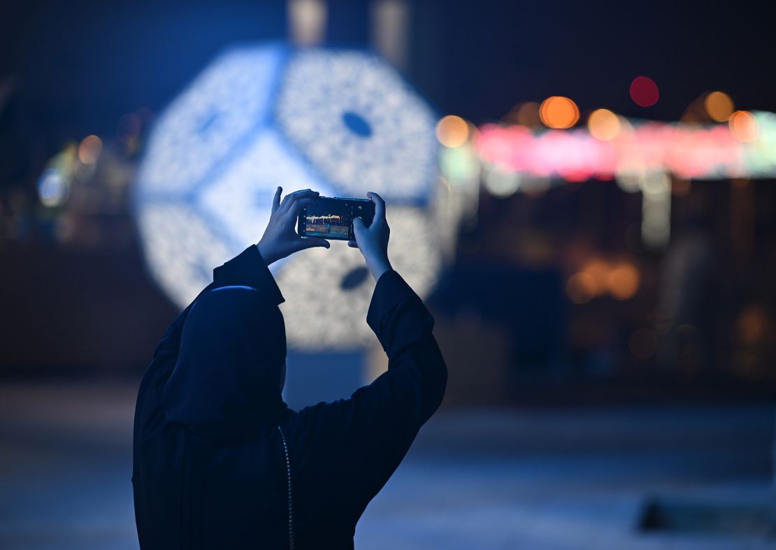 A football fan takes a picture at the Corniche ahead of the FIFA World Cup Qatar 2022 on November 19, 2022 in Doha.. 