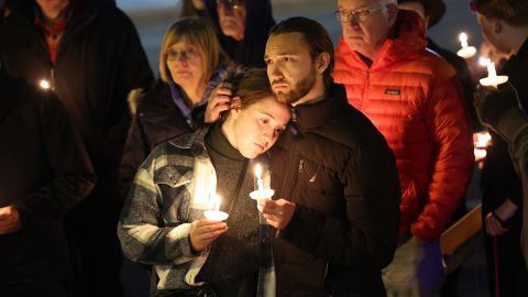 People gather Sunday at a vigil at a makeshift memorial near the Club Q nightclub.